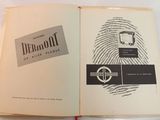 an open book with a picture of a cell phone on it