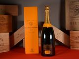 a bottle of champagne and a box of wine on a table