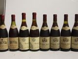six bottles of wine are lined up in a row on a table