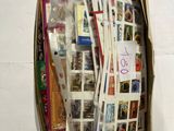a cardboard box full of postcards on the wall