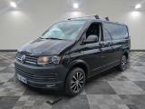 the black van is parked in a large room with checkered floor