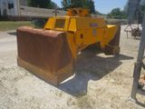 a yellow bulldozer that is sitting in the dirt