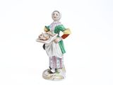 a figurine of a woman holding a tray of food