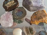 many rocks and stones on display in a glass case