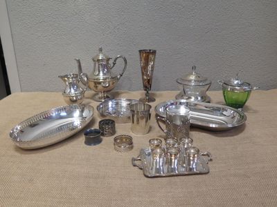 a table that has a lot of silver items on it