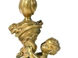 a gold statue of a child holding a vase