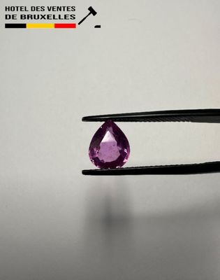 an image of a pair of pliers holding a purple gemstone