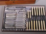 a wooden box with silverware in it on a table