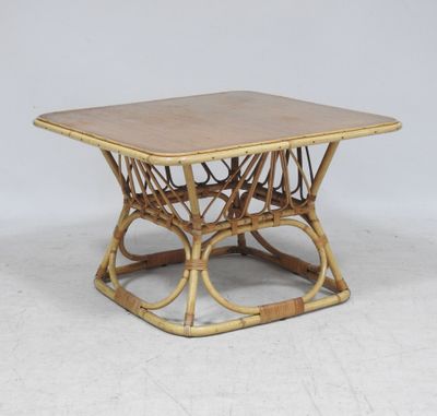 a close up of a bamboo table with a square top