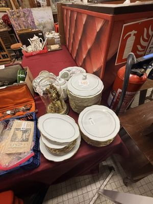 many plates and bowls sitting on a table in a room