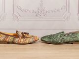 two pairs of shoes are sitting on a wooden floor
