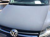 a grey vw van that is parked in a parking lot
