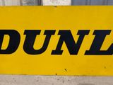 a sign that says dunz on it in front of a building