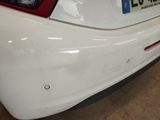 a white car with a number plate on the back of it