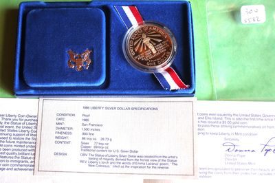 a blue box with a silver medal and a red, white, and blue ribbon