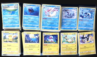 a lot of pokemon cards that are on the table