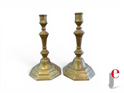 pair of antique brass candlesticks on a white background