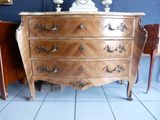 a dresser with a clock on top of it in a room