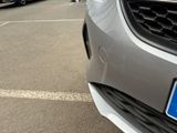 cars parked in a parking lot with a number plate on the front of the car