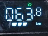 a close up of a digital clock on a motorcycle