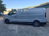 a silver van parked in a parking lot next to a building