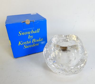 a small glass bowl sitting next to a blue box