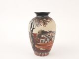 a vase with a painting on it sitting on a white surface