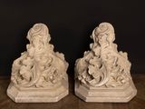 two statues of a woman and a man sitting on a bench