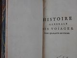an old book with writing on it sitting on a table