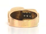 an image of a gold ring with a black diamond