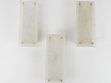 three white marble blocks sitting on top of a white surface