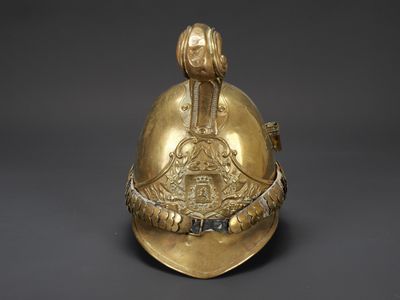 un casque doré surmonté d'un oiseau