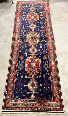 an image of a long blue rug with a red border