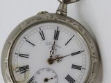 a silver pocket watch with roman numerals on it