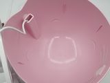 a pink bowl sitting on top of a white table