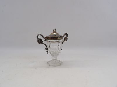 an antique silver plated glass cup with a handle and a lid