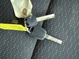 two keys attached to a car key on a seat belt