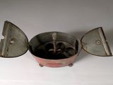 a small metal pot with a spoon inside of it