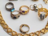 a lot of rings and bracelets on a table