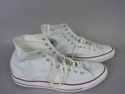 white converse sneakers with red and white laces are on a gray surface