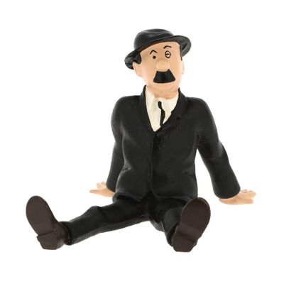 a figurine of a man sitting on the ground