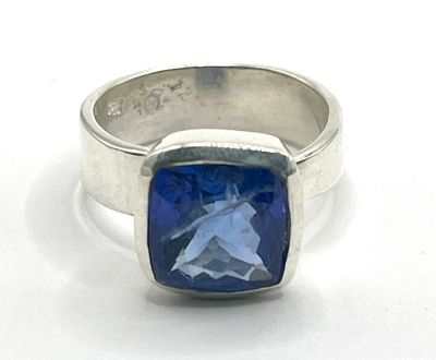 silver ring with a blue stone in the center