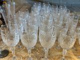 many empty wine glasses sitting on a wooden table