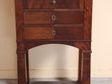 a small wooden table with a marble top on it