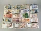 a lot of different bank notes that are on the table