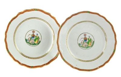 two plates with gold rims and a picture of a man and woman