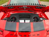 a close up of a red sports car with its hood open