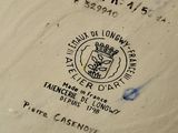 a plate with a picture of a coat of arms on it