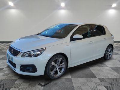 the white car is parked in the garage on a checkered floor
