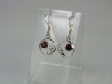 silver plated earrings with garnets and garnets on them